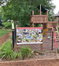 Bird identification sign near playground